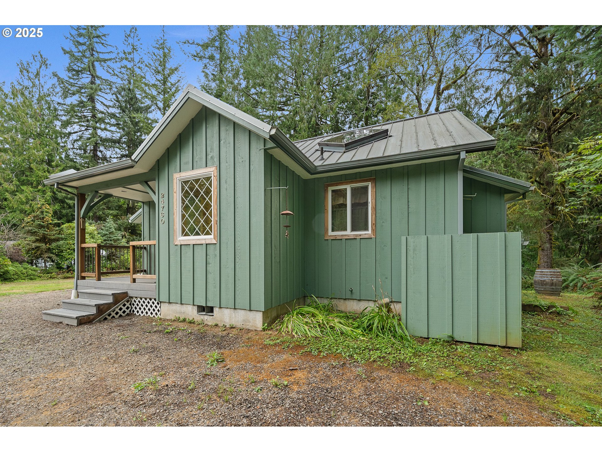 24760 Trask West Tillamook, OR 97141 - Photo 18 of 29 a backyard of a house with a barn table and chairs