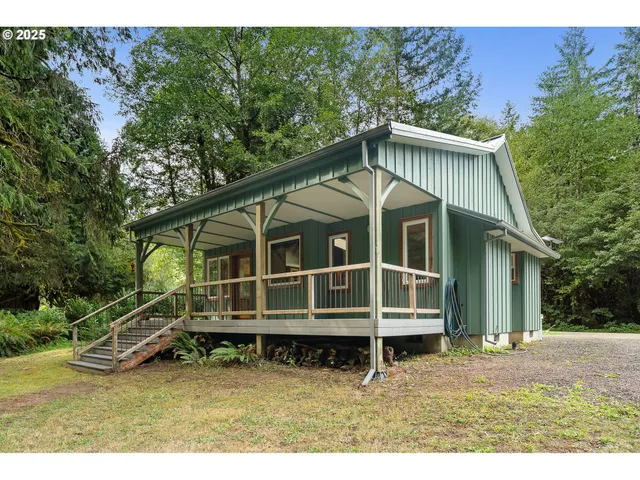 a view of a house with a small yard and wooden fence