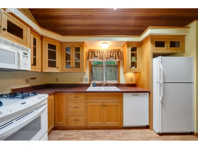 a kitchen with a stove a refrigerator and a cabinets