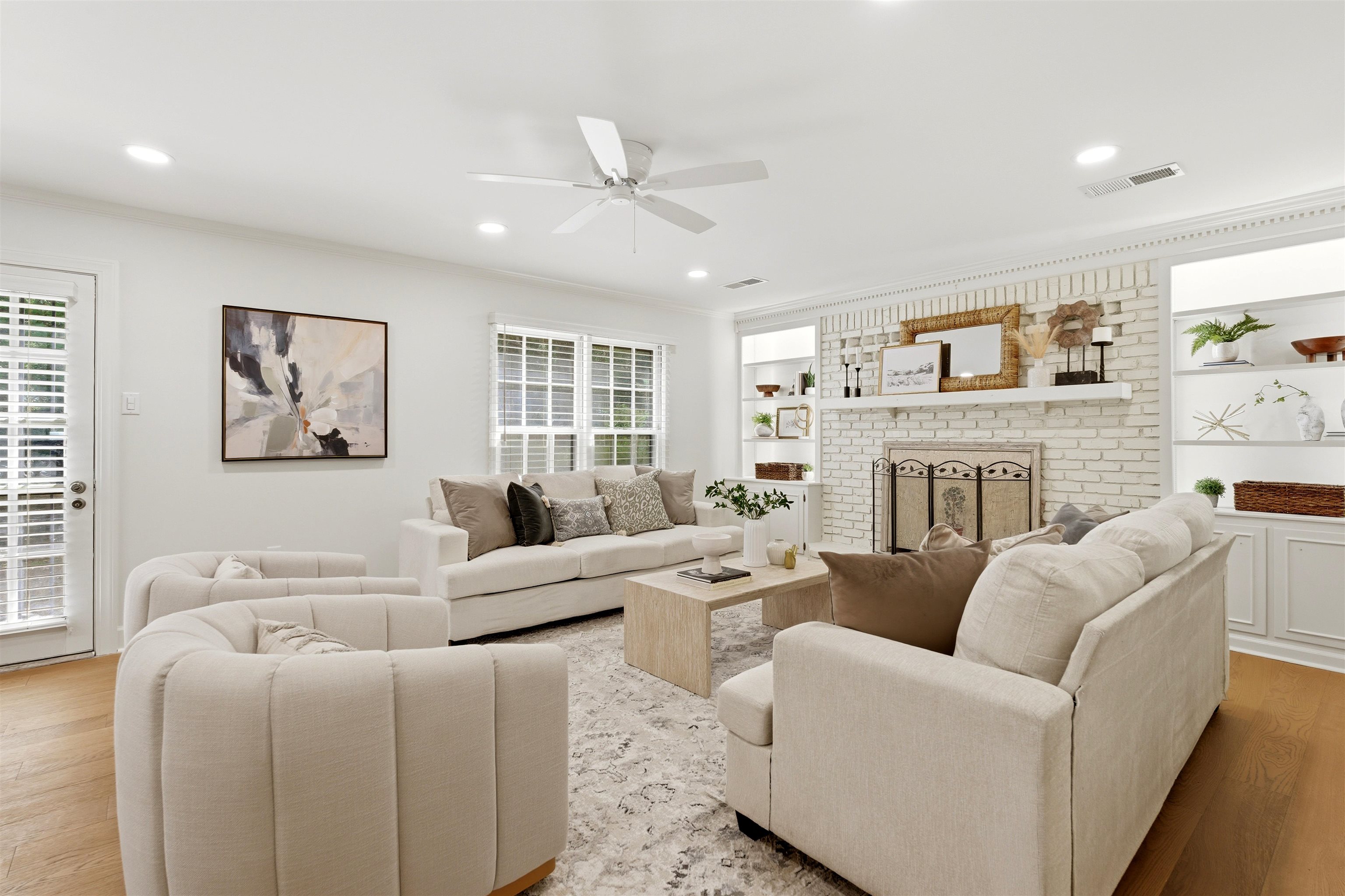 1984 Allenby Road Germantown, TN 38139 - Photo 19 of 37 Living area featuring a painted brick fireplace with a mantel, built-in shelving, wood-finish flooring, and a ceiling fan