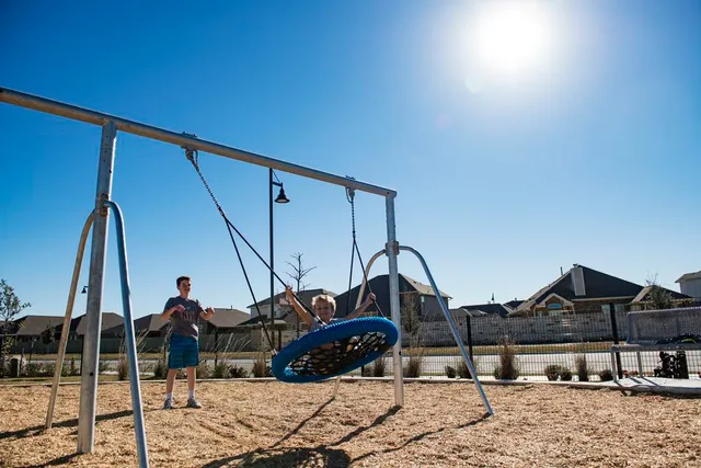 a living room with furniture gym equipment and a large window