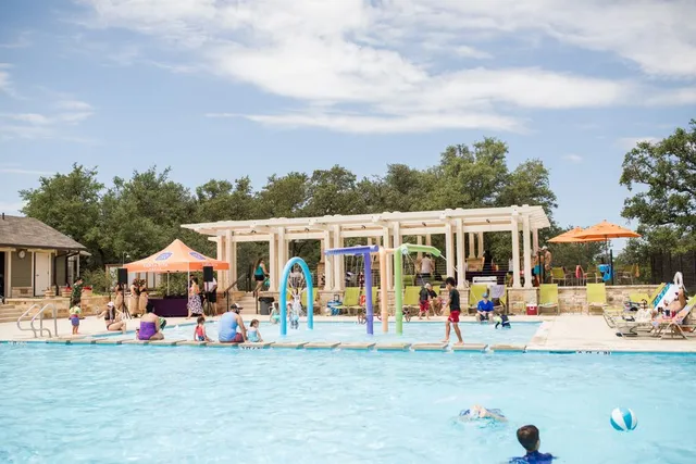 a view of an chairs and table tv in front of a house
