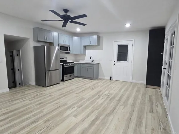 a large kitchen with cabinets and stainless steel appliances