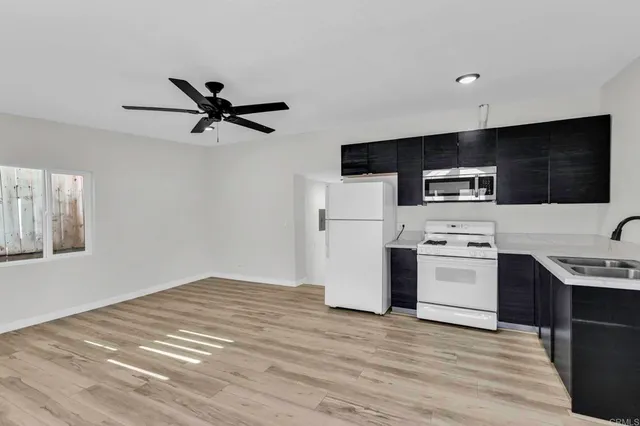 a kitchen with stainless steel appliances kitchen island a refrigerator sink and stove