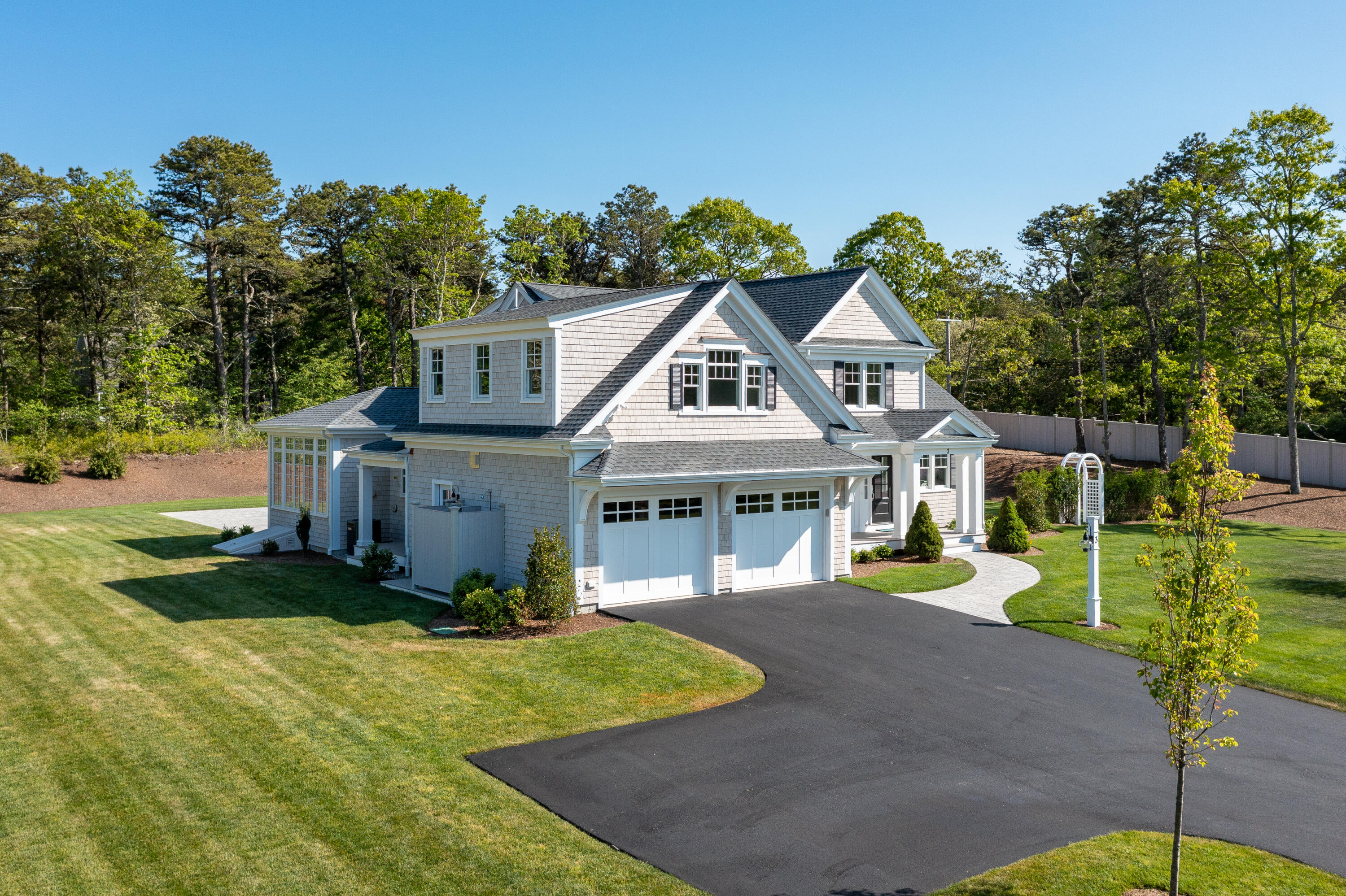 3 Elijah's Wds Harwich, MA 02645 - Photo 39 of 43 a front view of a house with a yard and garage
