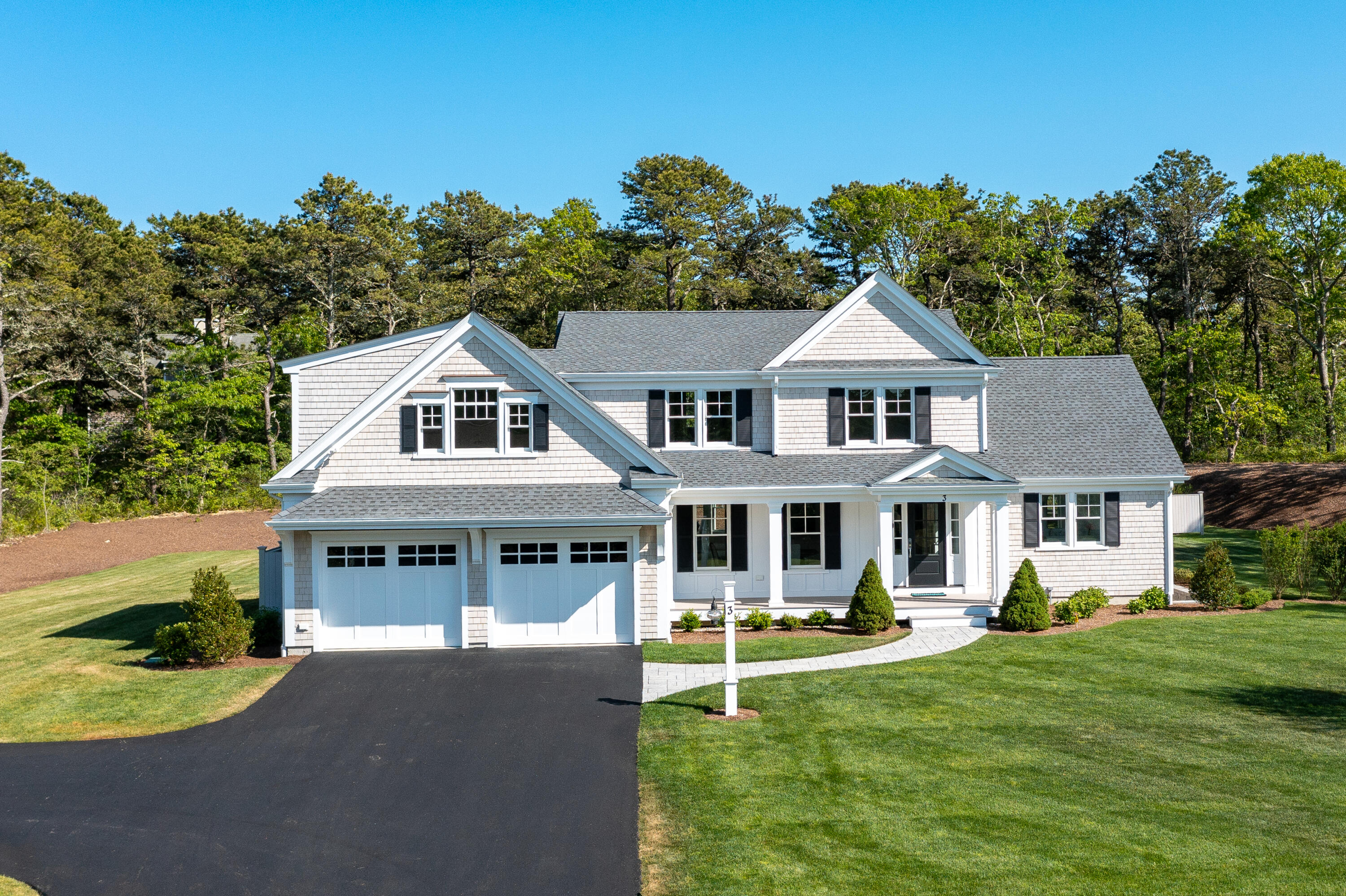 3 Elijah's Wds Harwich, MA 02645 - Photo 40 of 43 a front view of a house with a yard table and chairs