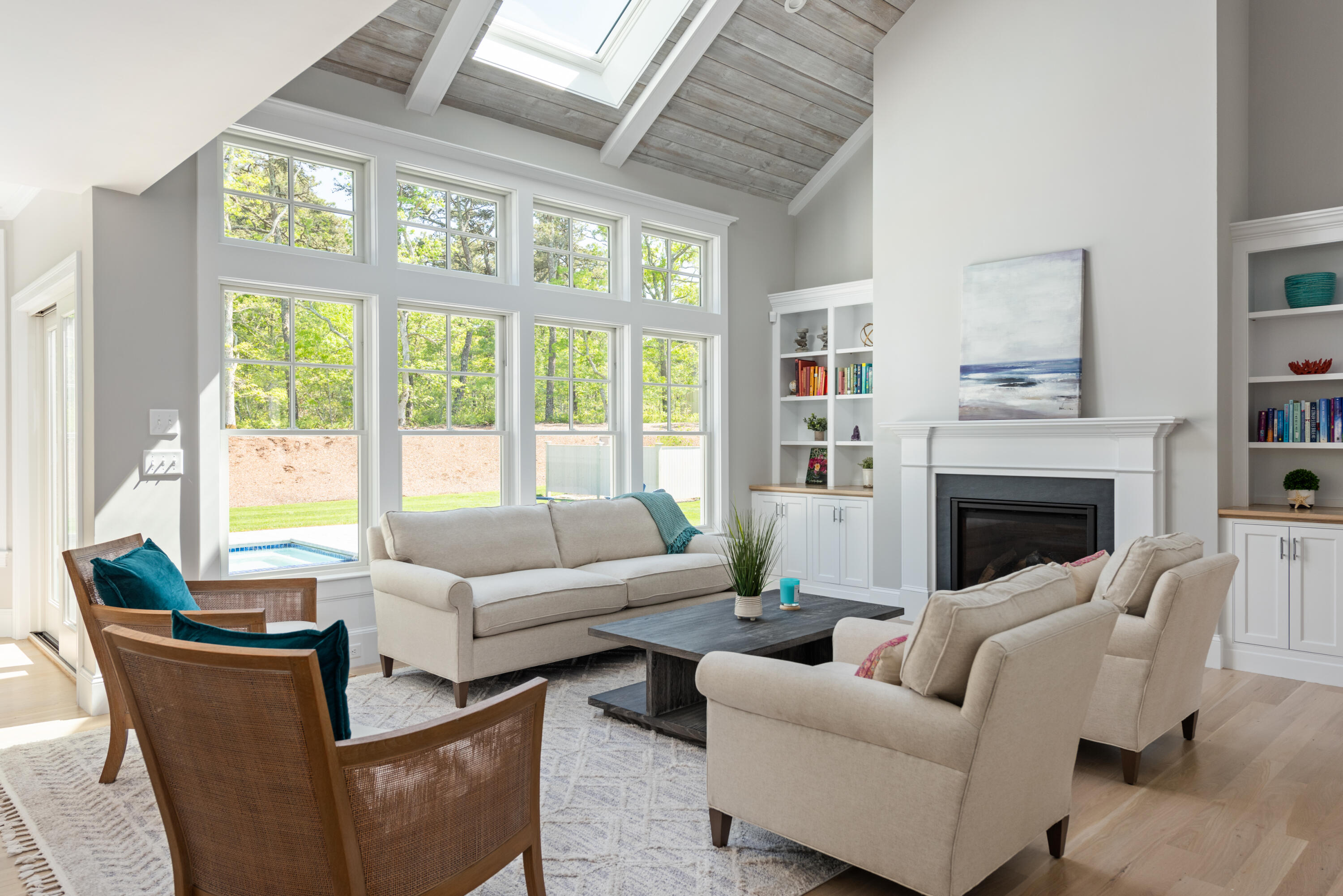 3 Elijah's Wds Harwich, MA 02645 - Photo 10 of 43 a living room with furniture large windows and a fireplace