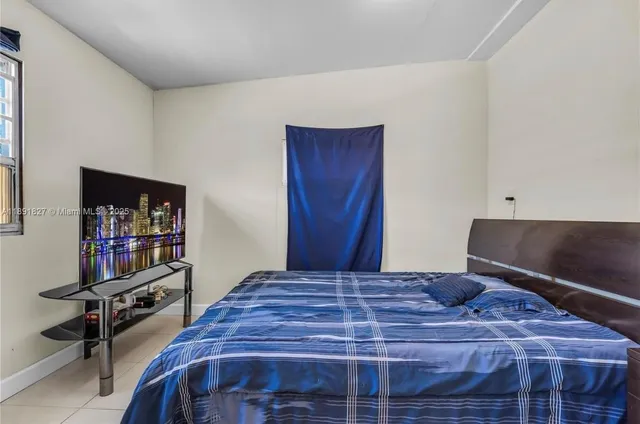 a bedroom with a bed and a dresser in it