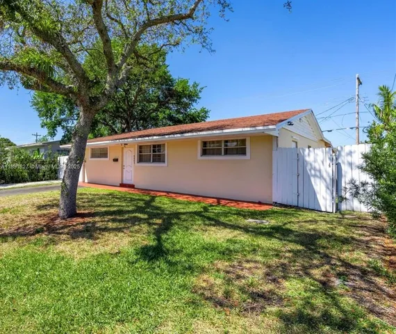 a view of a backyard with large trees