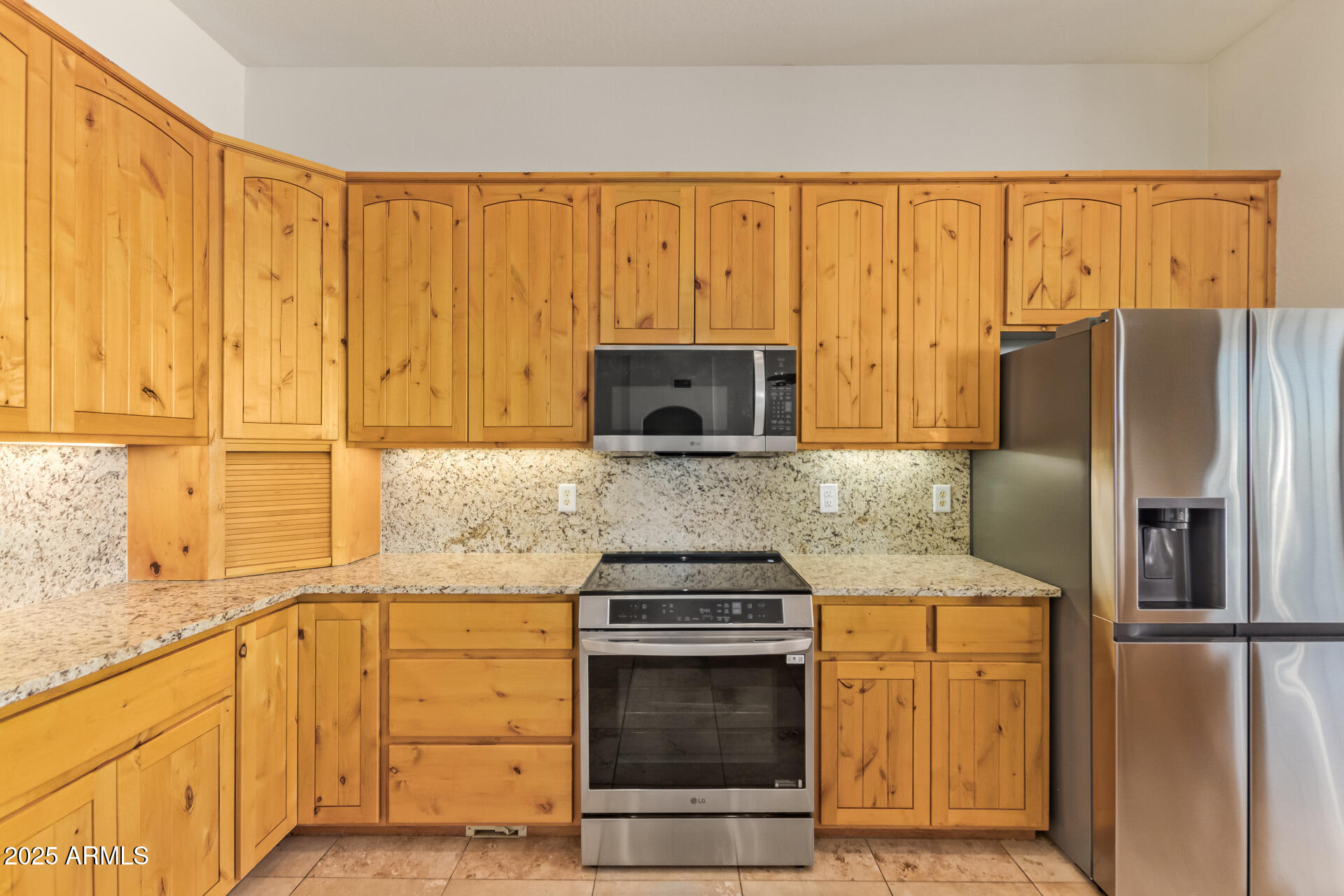 945 North Mountain View Road Apache Junction, AZ 85119 - Photo 16 of 53 a kitchen with stainless steel appliances granite countertop a refrigerator stove and sink