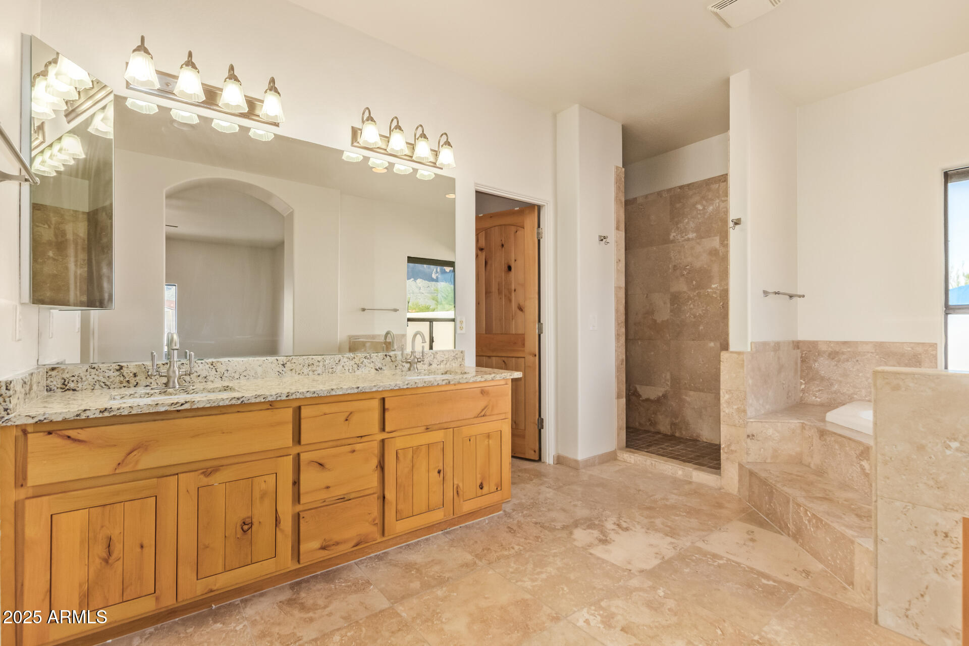 945 North Mountain View Road Apache Junction, AZ 85119 - Photo 22 of 53 a spacious bathroom with a granite countertop sink a mirror and a shower