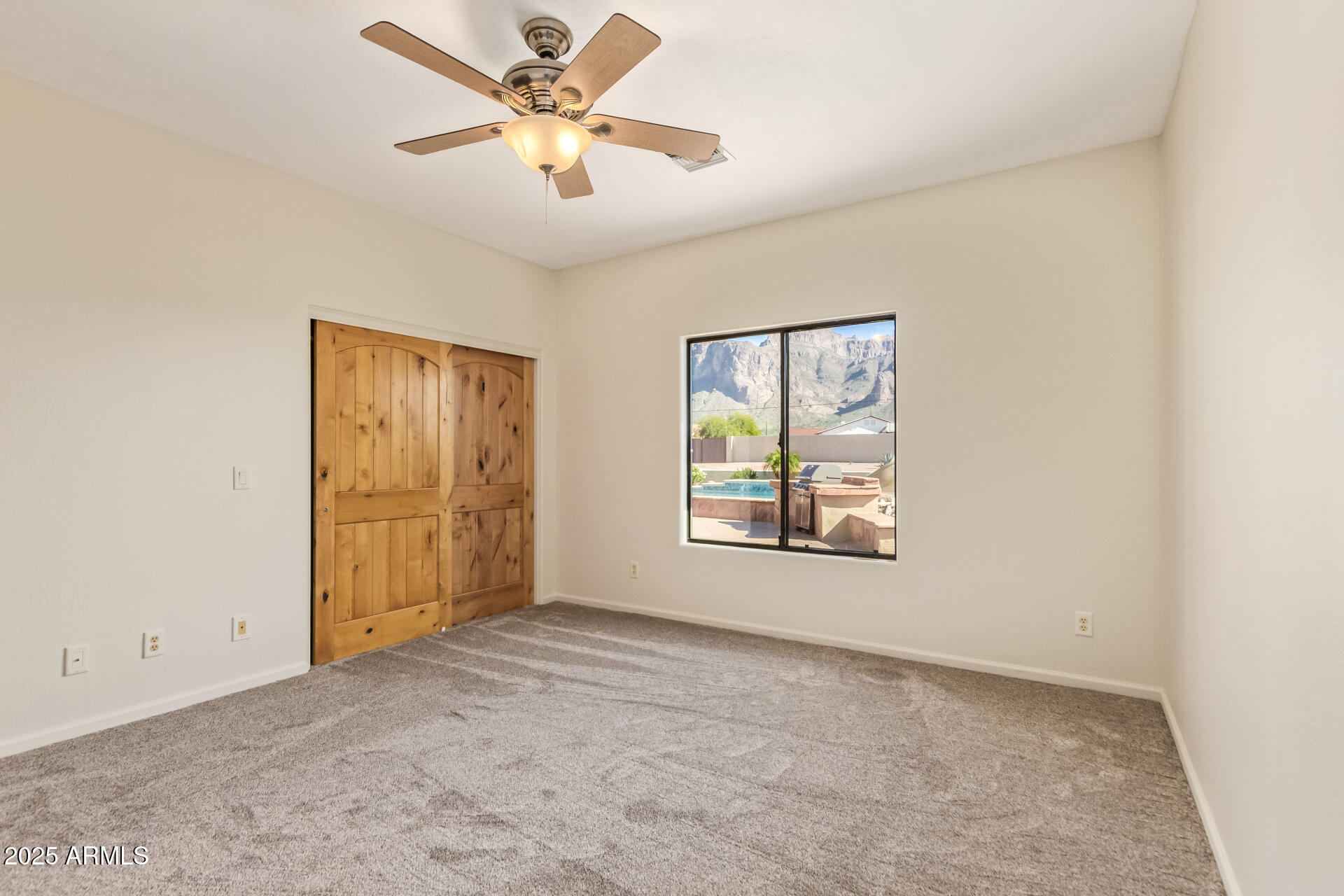 945 North Mountain View Road Apache Junction, AZ 85119 - Photo 27 of 53 an empty room with windows and fan