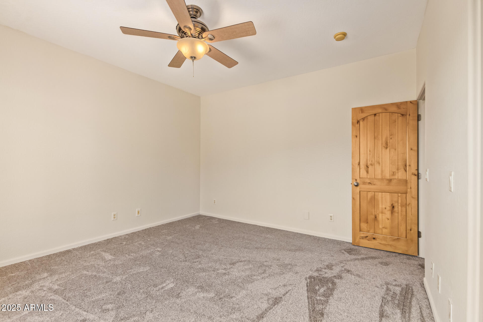 945 North Mountain View Road Apache Junction, AZ 85119 - Photo 28 of 53 an empty room with a ceiling fan and carpet