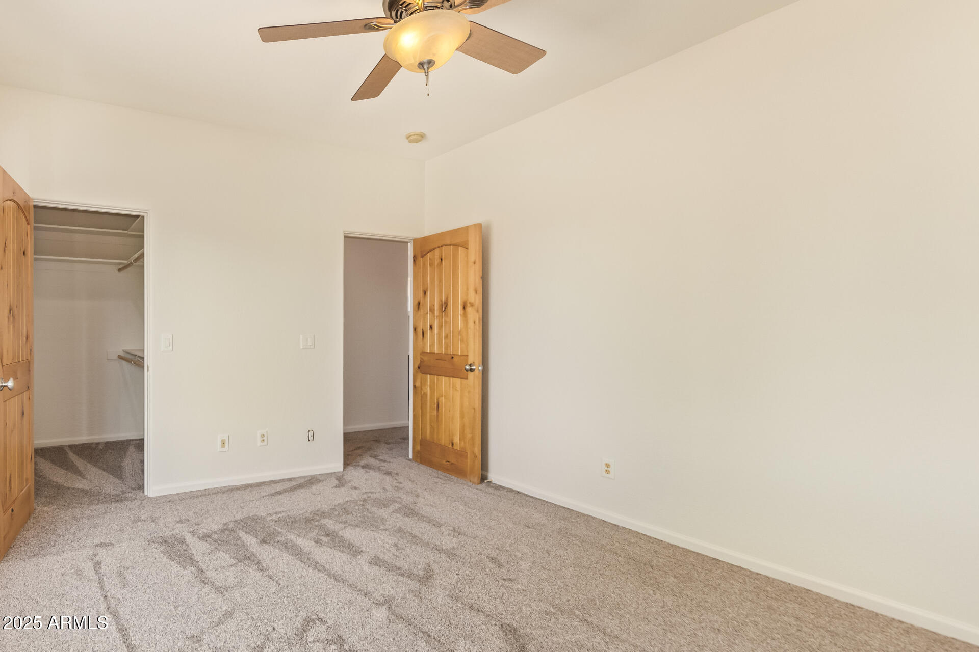 945 North Mountain View Road Apache Junction, AZ 85119 - Photo 30 of 53 an empty room with a ceiling fan and carpet