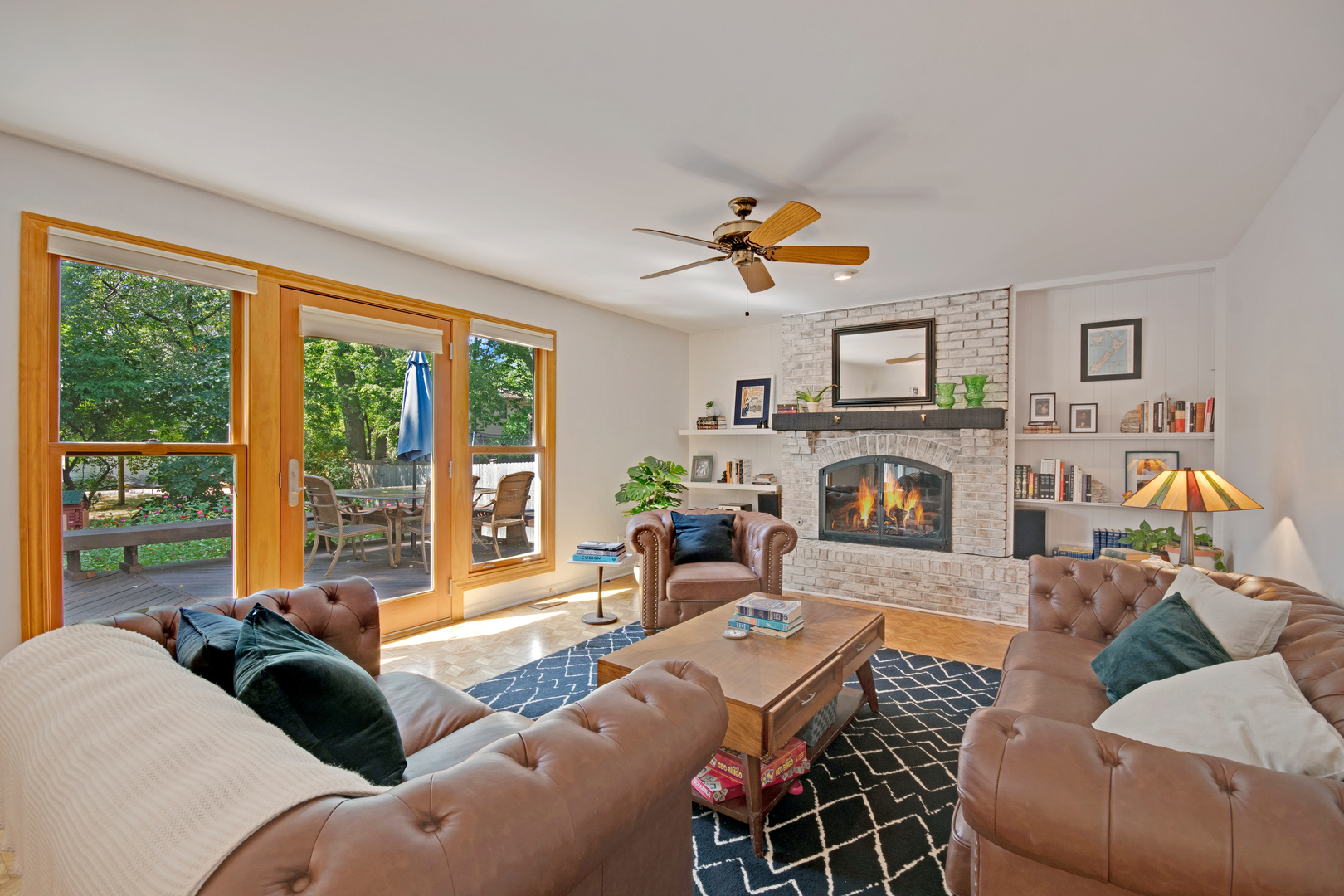 1214 Arthur Road Naperville, IL 60540 - Photo 4 of 21 a living room with furniture a fireplace a large window and a flat screen tv