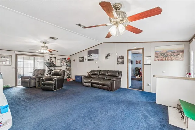 a bedroom with furniture and a large window