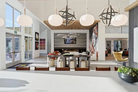 a living room with fireplace chandelier and a mirror