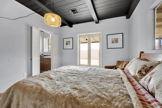 a bedroom with bed and wooden floor