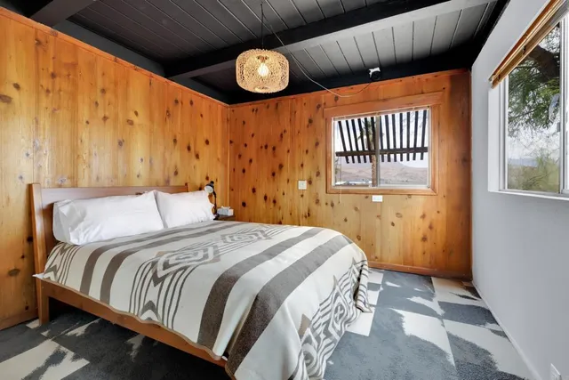 a bedroom with a bed and window