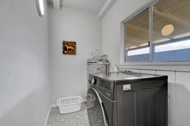 a bathroom with a sink a toilet and a window