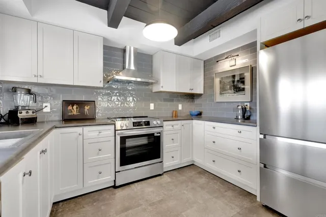 a kitchen with cabinets stainless steel appliances and sink