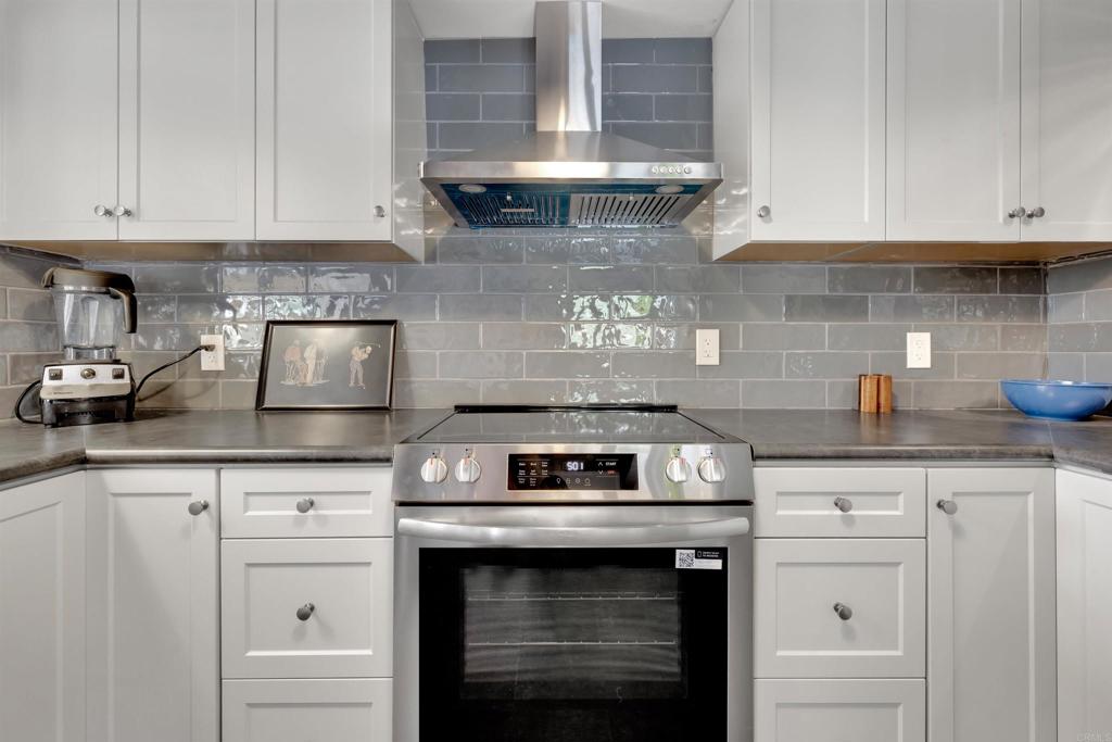 3211 Broken Arrow Road Borrego Springs, CA 92004 - Photo 6 of 46 a kitchen with granite countertop white cabinets and a stove