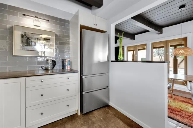 a kitchen with stainless steel appliances a refrigerator and a stove