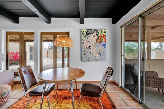 a view of a dining room with furniture wooden floor and a chandelier