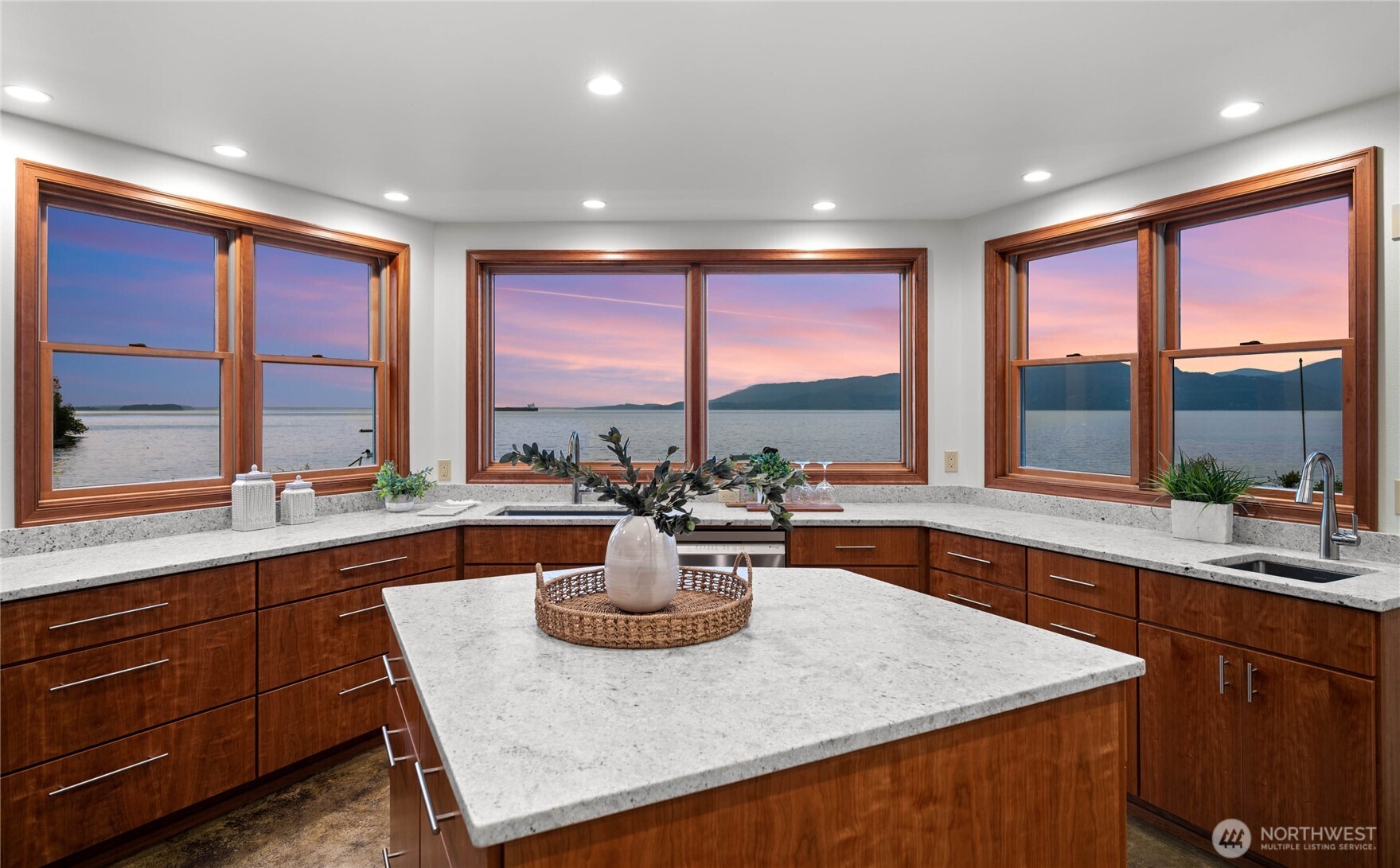 a kitchen with a large window and a sink