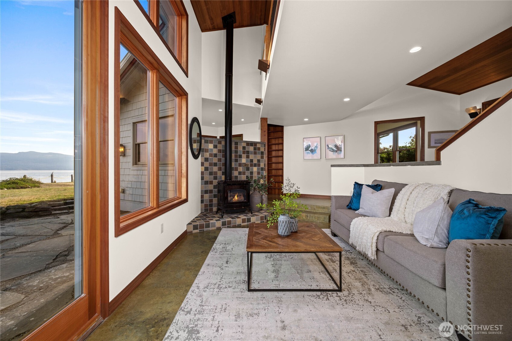 9551 Samish Island Road Bow, WA 98232 - Photo 20 of 40 a living room with furniture wooden floor and a large window