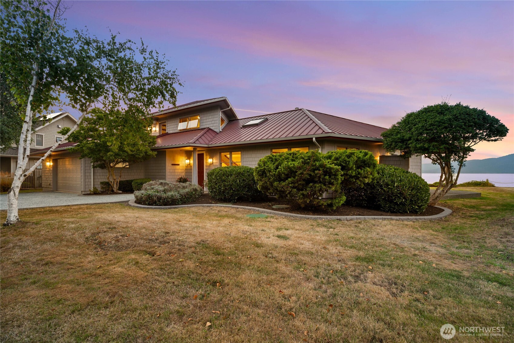 9551 Samish Island Road Bow, WA 98232 - Photo 5 of 40 a front view of a house with a yard and garage