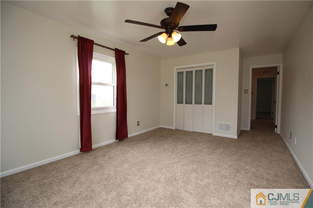 24 Gilmore Road Ewing, NJ 08628 - Photo 14 of 22 an empty room that has a window and a ceiling fan