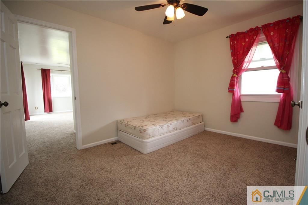24 Gilmore Road Ewing, NJ 08628 - Photo 16 of 22 an empty room with windows and chandelier