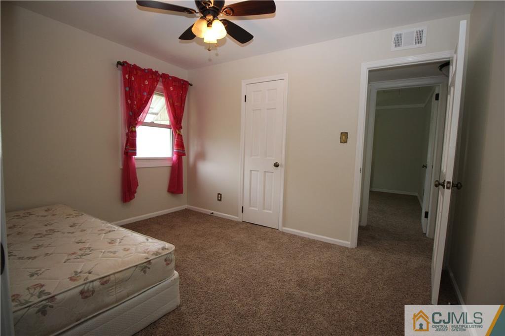 24 Gilmore Road Ewing, NJ 08628 - Photo 17 of 22 a bedroom with a bed and a chandelier