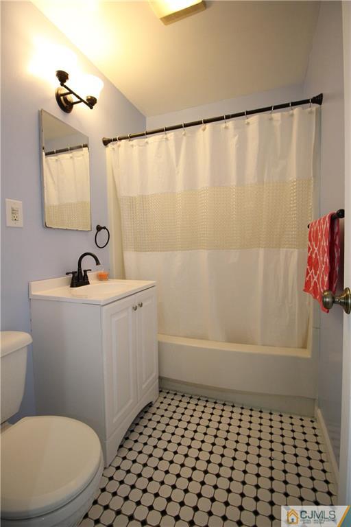 24 Gilmore Road Ewing, NJ 08628 - Photo 19 of 22 a bathroom with a sink a toilet a shower curtain and a mirror