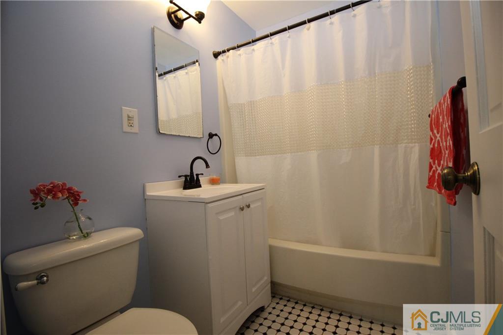 24 Gilmore Road Ewing, NJ 08628 - Photo 20 of 22 a bathroom with a sink a toilet and shower