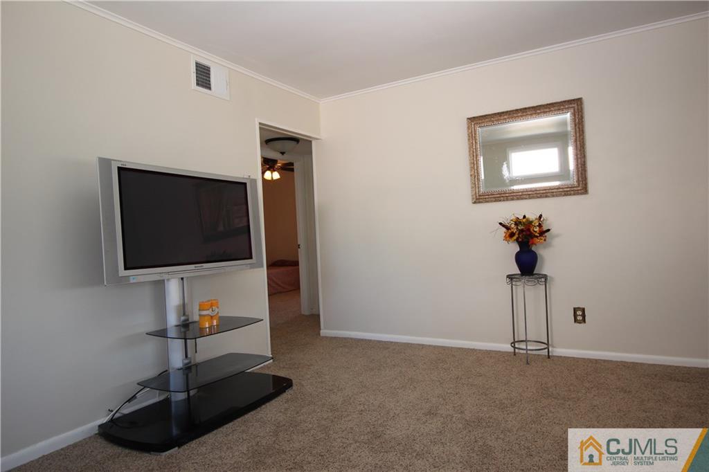 24 Gilmore Road Ewing, NJ 08628 - Photo 4 of 22 a living room with furniture and a flat screen tv