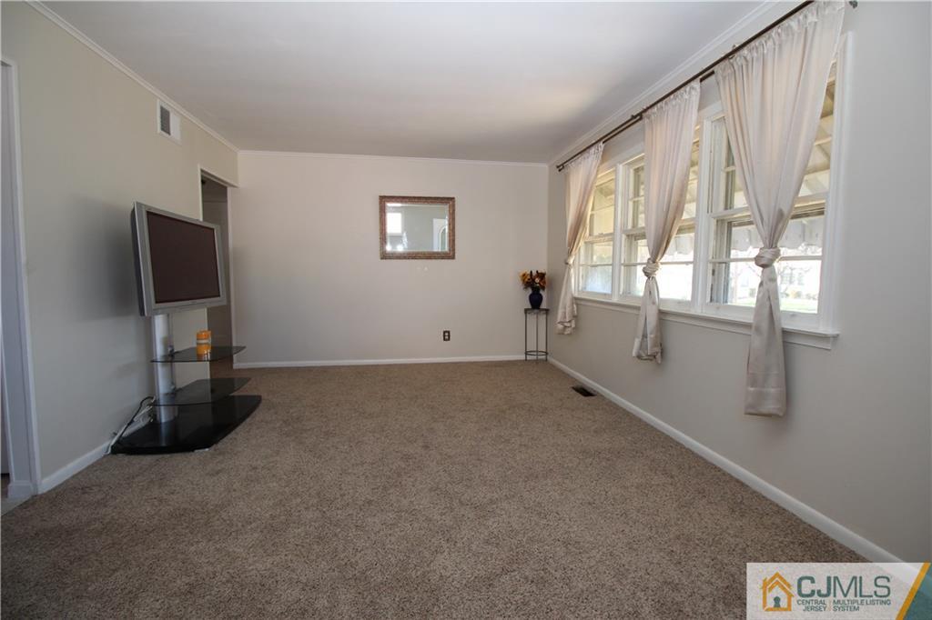 24 Gilmore Road Ewing, NJ 08628 - Photo 6 of 22 a view of a livingroom with an empty space and a window