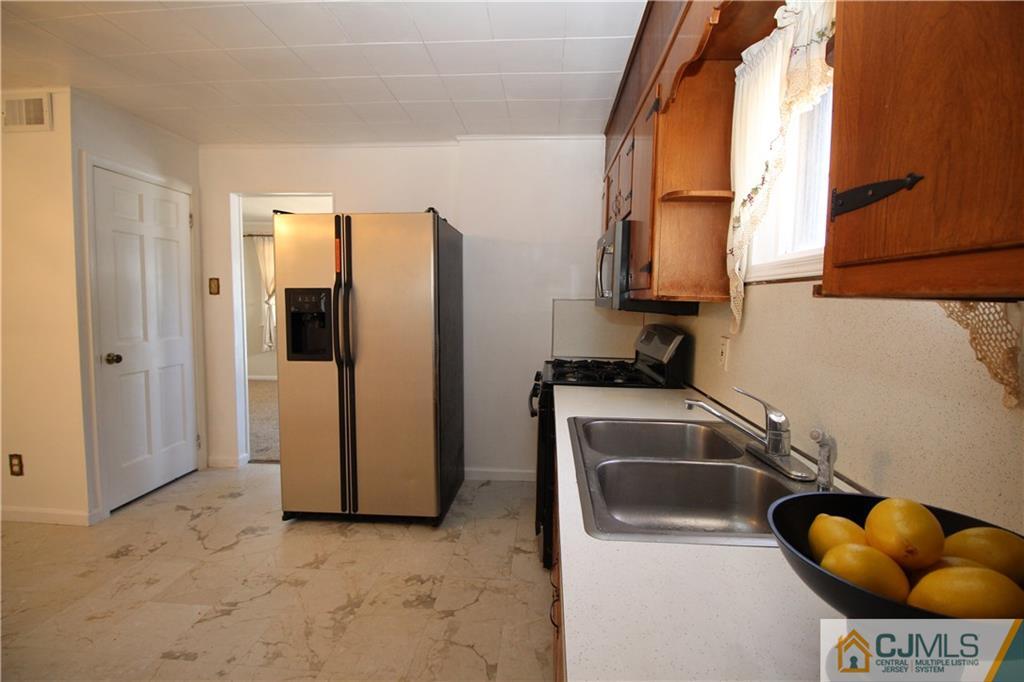 24 Gilmore Road Ewing, NJ 08628 - Photo 7 of 22 a kitchen with a sink and a refrigerator