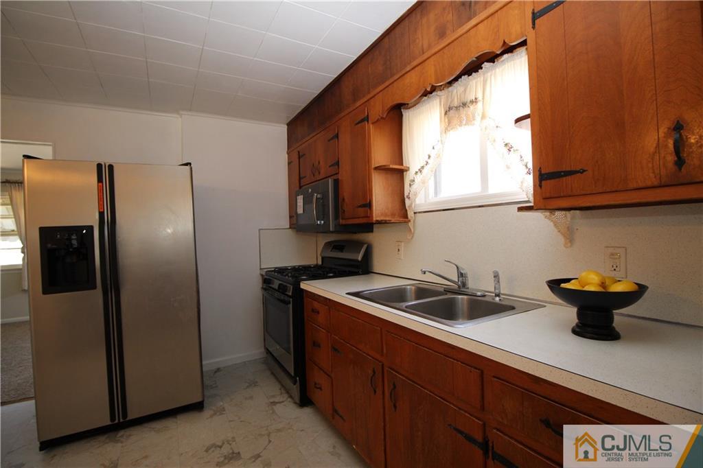 24 Gilmore Road Ewing, NJ 08628 - Photo 8 of 22 a kitchen with stainless steel appliances a sink a refrigerator and a window