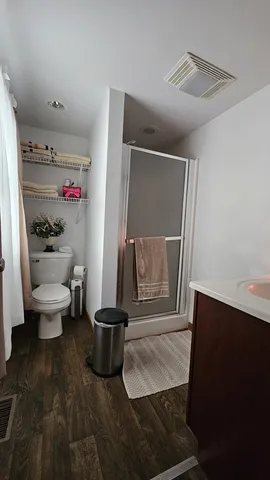 a bathroom with a toilet and a shower