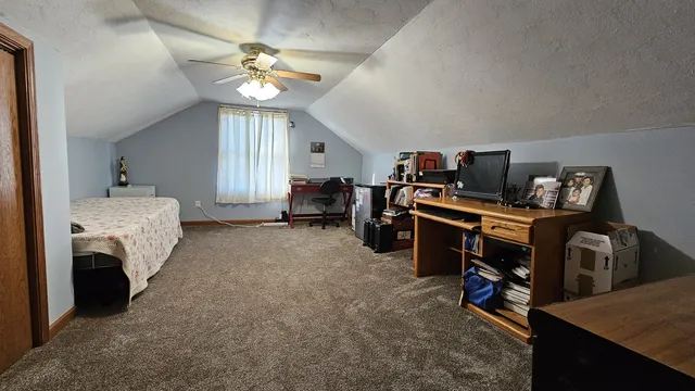 a bedroom with furniture and a window