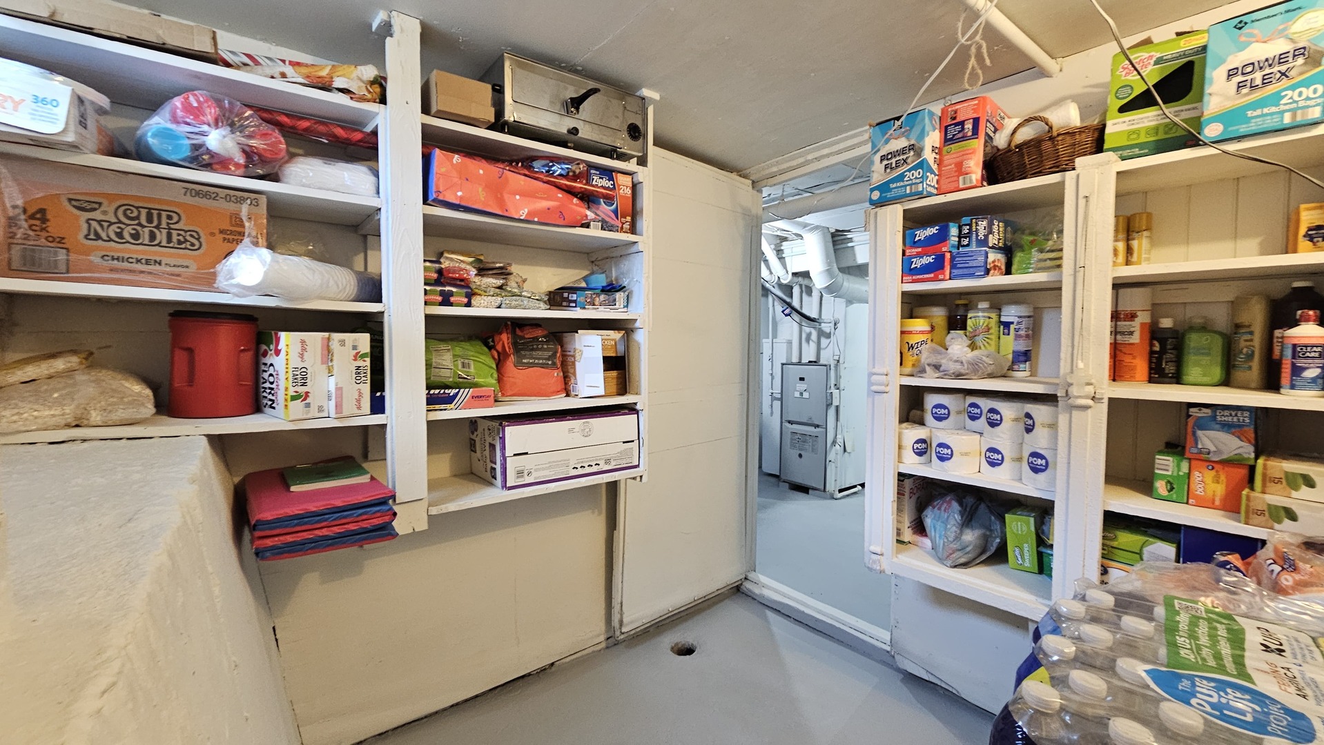 703 Lincoln Street Harvard, IL 60033 - Photo 22 of 27 a room with fridge and a book shelf