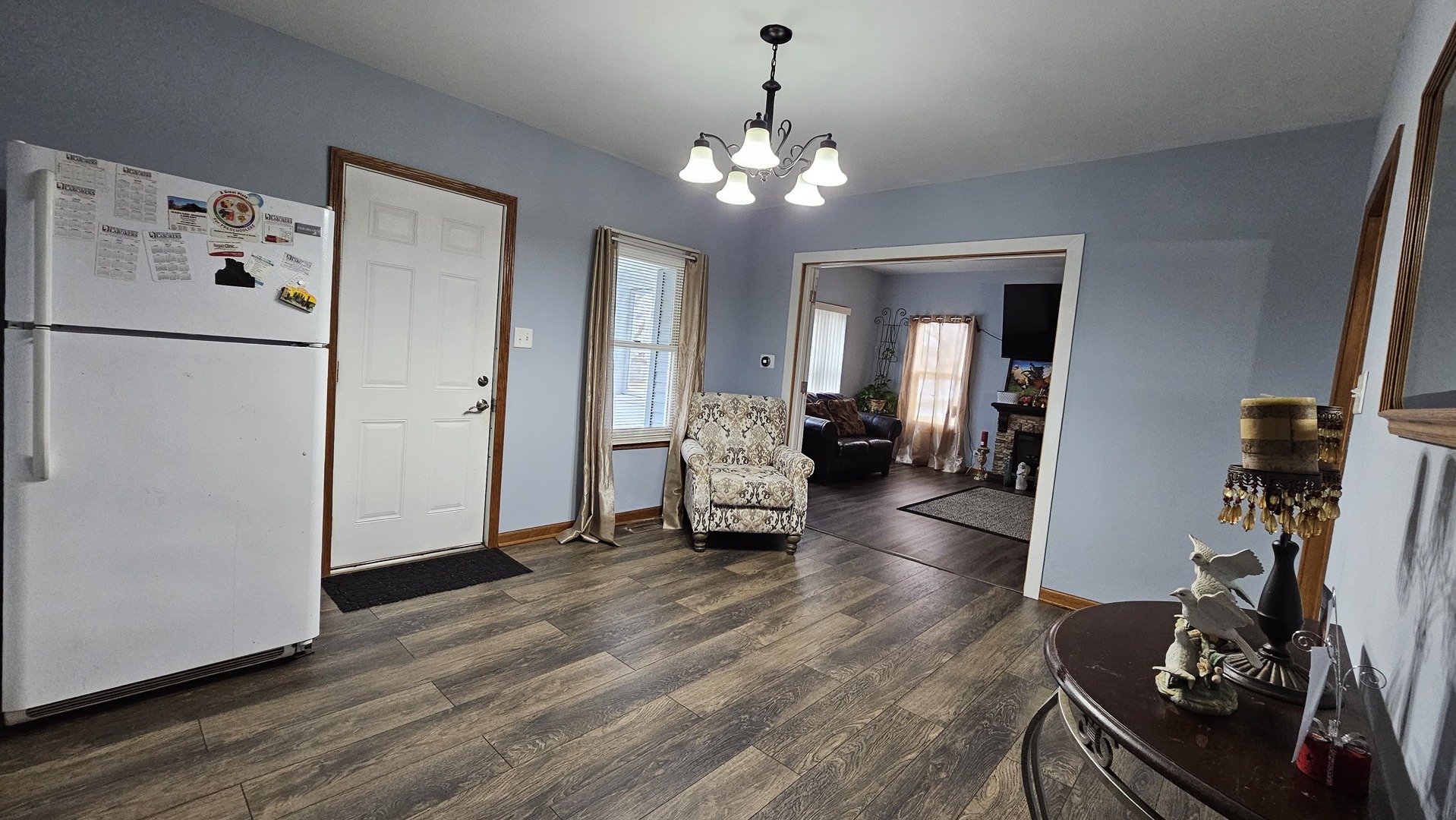 703 Lincoln Street Harvard, IL 60033 - Photo 6 of 27 a living room with furniture and a chandelier