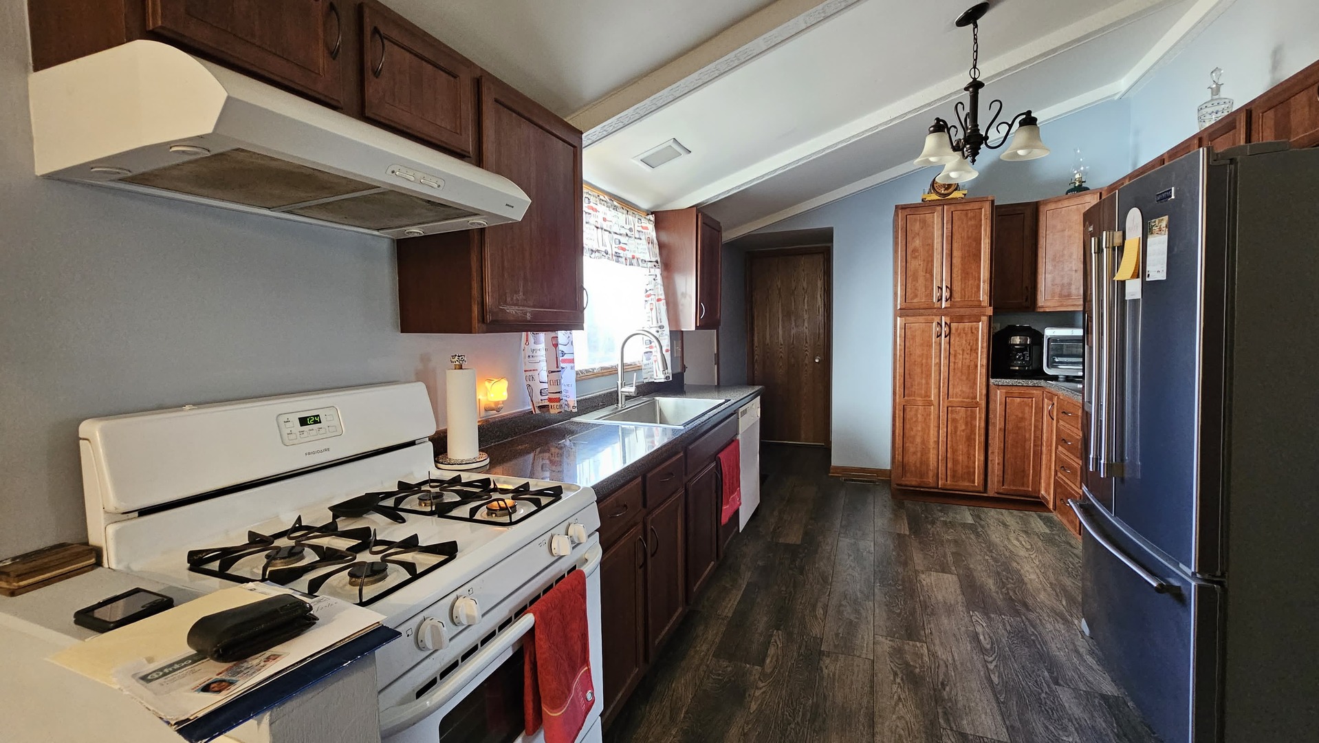 703 Lincoln Street Harvard, IL 60033 - Photo 8 of 27 a kitchen with stainless steel appliances granite countertop a stove and a refrigerator