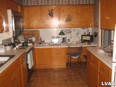 640 Bok Road Nazareth, PA 18064 - Photo 11 of 28 a kitchen with stainless steel appliances granite countertop a sink a stove and a refrigerator