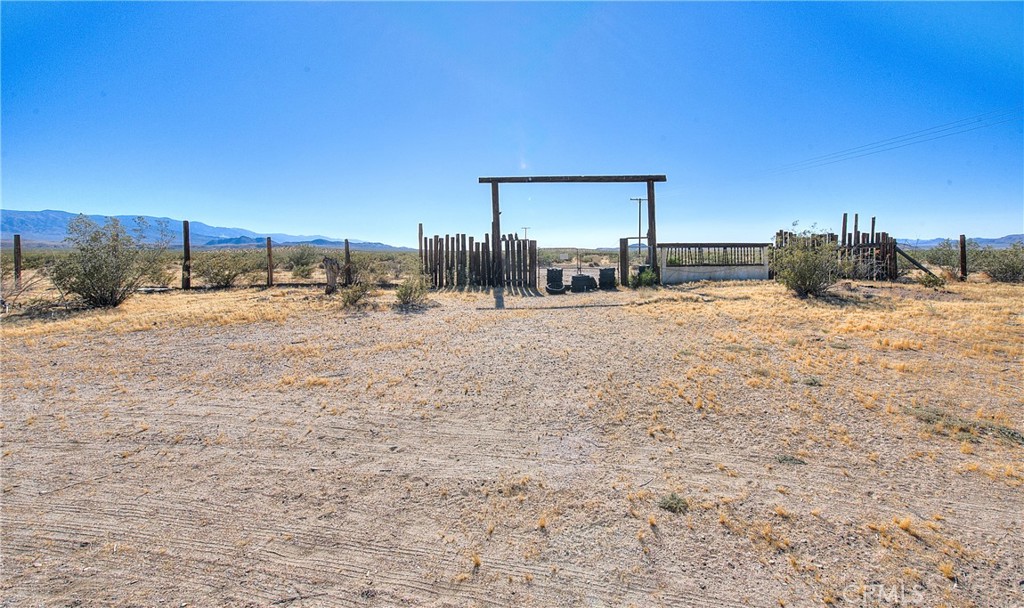 45757 Paddington Road Lucerne Valley, CA 92356 - Photo 14 of 18 a view of a dirt road and a building in the background