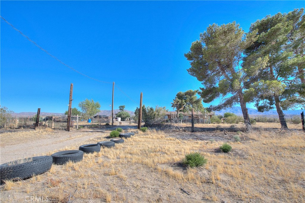 45757 Paddington Road Lucerne Valley, CA 92356 - Photo 17 of 18 a backyard of a house with table and chairs