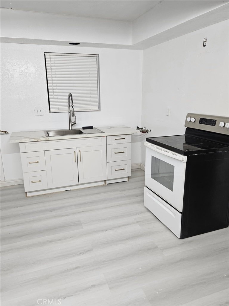45757 Paddington Road Lucerne Valley, CA 92356 - Photo 5 of 18 a white kitchen with sink and dishwasher