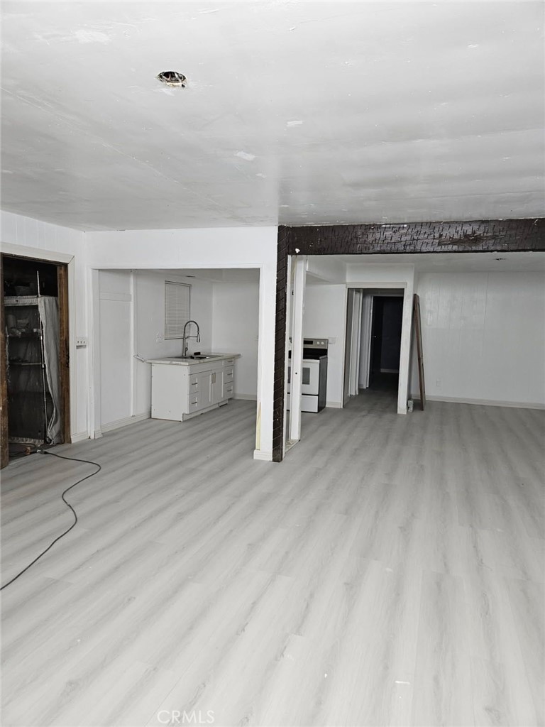 45757 Paddington Road Lucerne Valley, CA 92356 - Photo 6 of 18 a view of a room with wooden floor and entryway
